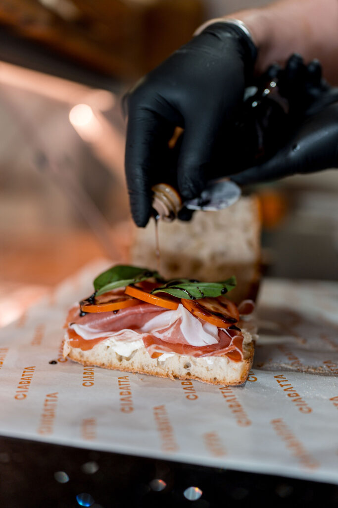 Vincotto being drizzled on panini Ciabatta Italian Takeaway North Sydney Paninis Pastries Coffee